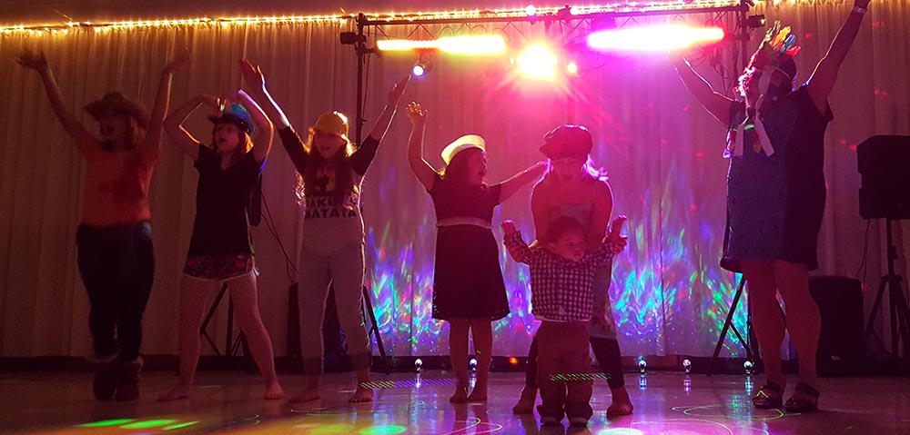 Girls singing and performing to YMCA